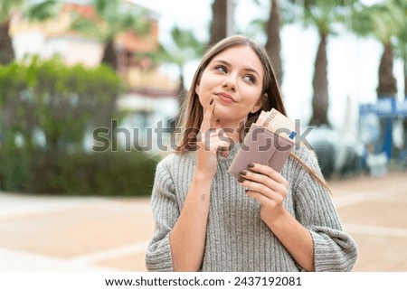 Young pretty blonde woman holding wallet with money Royalty-Free Stock Photo #2437192081