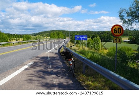 road, field, forest and traffic sign