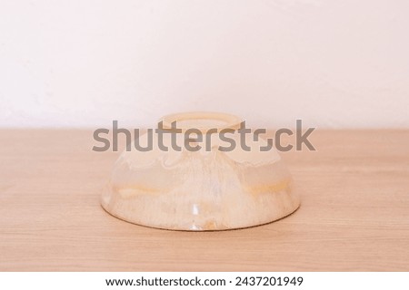 Handmade ceramic bowl, white and beige, wooden. High quality photo
