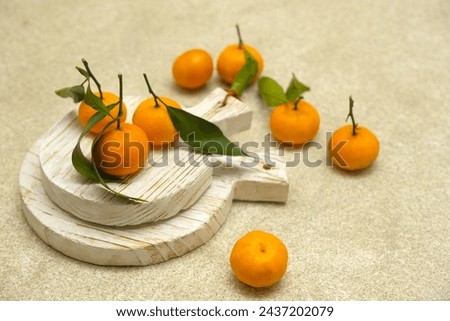 Small orange or tangarine on brown background. Jeruk Royalty-Free Stock Photo #2437202079