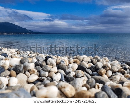 colourful waters of Fagnano lake, Tolhuin, Tierra del Fuego, Argentina Royalty-Free Stock Photo #2437214625