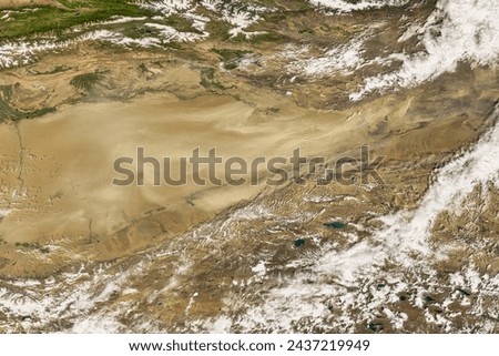 Taklimakan Dust Storm. . Elements of this image furnished by NASA.