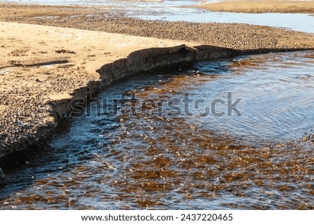 Coastal erosion captured a stark reminder of nature power and the environment fragility. Royalty-Free Stock Photo #2437220465