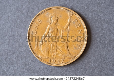 A British one penny coin dated 1947, Pre-decimal coinage numismatics. Royalty-Free Stock Photo #2437224867