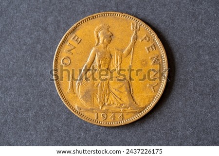 A British one penny coin dated 1944. Pre-decimal copper coinage numismatics. Royalty-Free Stock Photo #2437226175