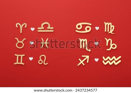 Zodiac signs compatibility on red background, flat lay Royalty-Free Stock Photo #2437234577