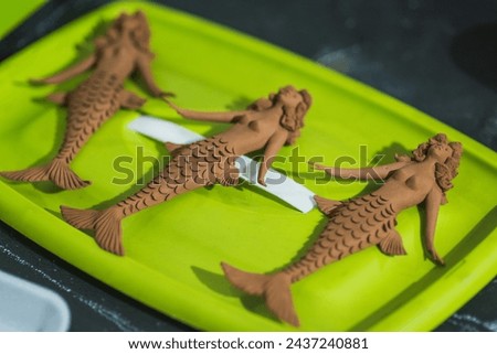 Small mermaid figures made of clay, traditional Mexican crafts.