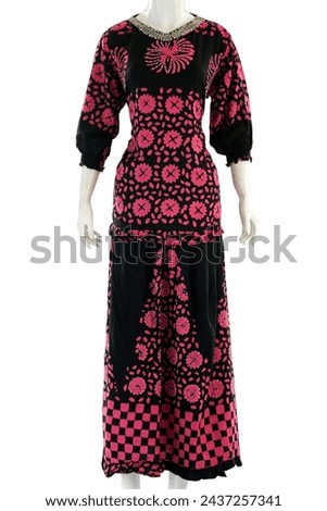 Women's suit with long sleeves, long skirt, have a feminine pattern made from soft and cool satin. Royalty-Free Stock Photo #2437257341