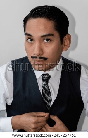 Latin man with drawn mustache headshot on white background
