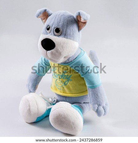 Plush toy blue dog on a white background.