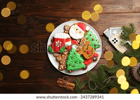 Different tasty Christmas cookies and decor on wooden table, flat lay. Space for text