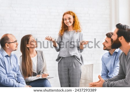 Recovery Stories. Positive young woman telling how she overcame drug addiction to people at group therapy session in rehab, sharing her experience Royalty-Free Stock Photo #2437293389