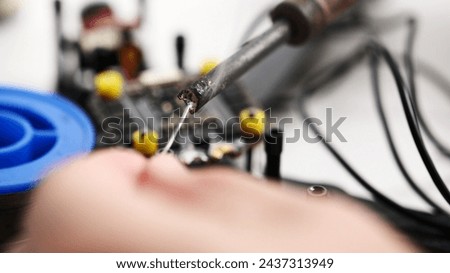 DIY assembly FTV copter, soldering microchips and motor connections Royalty-Free Stock Photo #2437313949