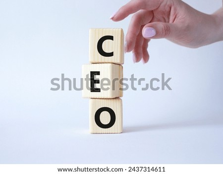 CEO - Chief executive officer symbol. Concept word CEO on wooden cubes. Businessman hand. Beautiful white background. Business and CEO concept. Copy space.