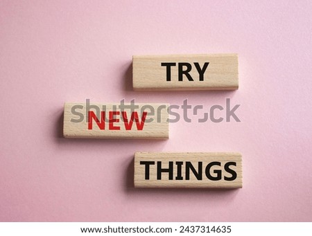 Try new Things symbol. Concept words Try new Things on wooden blocks. Beautiful pink background. Business and Try new Things concept. Copy space. Royalty-Free Stock Photo #2437314635