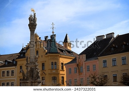 Authentic historical houses skyline. Loket city main square. Column with latin inscriptions. Negative space. Royalty-Free Stock Photo #2437322031
