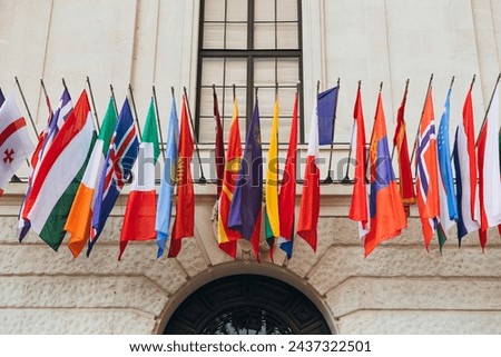 National flags of various countries flying in the wind. Colorful flags from different countries. Flags Organization for Security and Co-operation in Europe Royalty-Free Stock Photo #2437322501