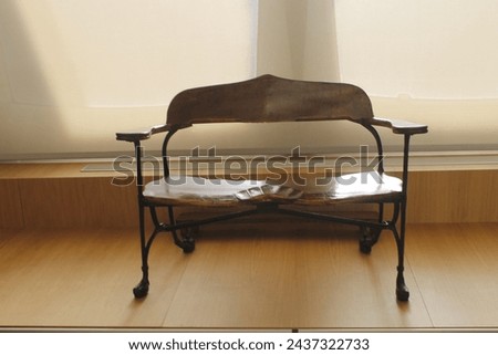 ancient iron bench inside a museum Royalty-Free Stock Photo #2437322733