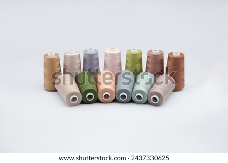 Thread spools background. Various colors sewing kit. Collection of threads. Pale pastel colors. Sew threads. Colorful hobby background. Tailor shop texture. Isolated on white. Royalty-Free Stock Photo #2437330625