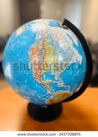 This stock image features a shuttle orbiting the Earth, highlighting the globe in the background. The shuttle, with its sleek design and prominent silhouette, gracefully navigates the vast expanse. Royalty-Free Stock Photo #2437338895