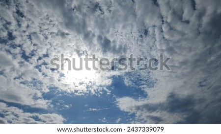 chiaroscuro on soft clouds in blinding sunlight in a blue sky Royalty-Free Stock Photo #2437339079