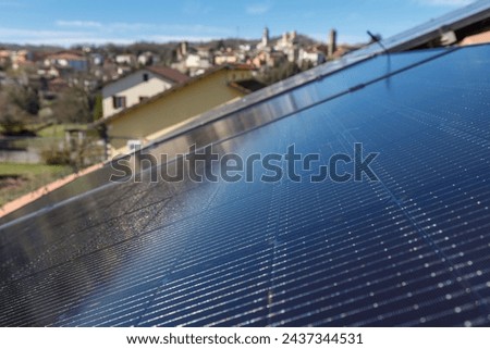 Installing PV photovoltaic  solar panels on the roof. No people are visible, close up image in daylight.