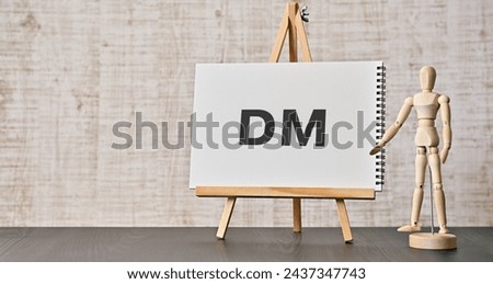 There is notebook with the word DM. It is an abbreviation for Direct message as eye-catching image. Royalty-Free Stock Photo #2437347743