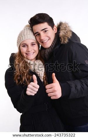 isolated studio portrait of a happy young couple in winter outfit