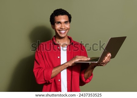 Photo of confident good mood guy wear red shirt texting apple iphone modern device isolated khaki color background