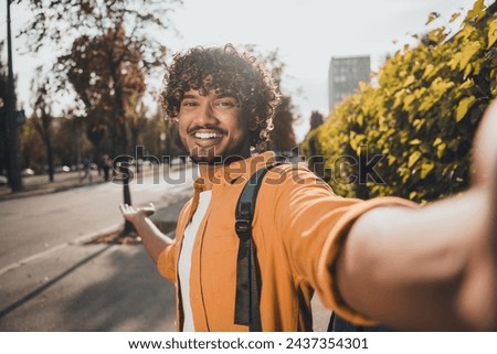 Photo of positive good mood nice man wear trendy clothes showing video blog showing park sunny weather outdoors