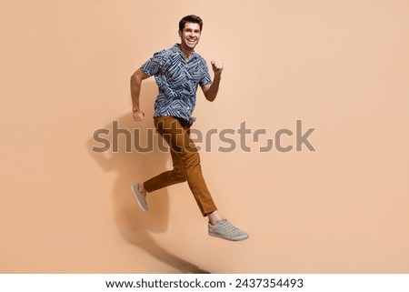 Profile full body photo of energetic motivated young man workaholic running to get promotion in career islated on beige color background