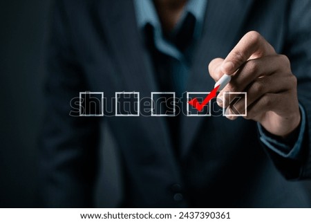 Checklist concept. Businessman using pen to checking mark on checkboxes on virtual screen.