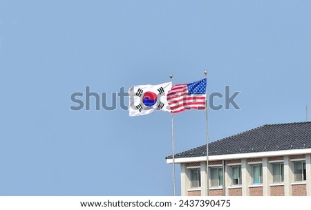 Flying the American flag and South Korean Flag, Star-Spangled Banner and Taegeukgi