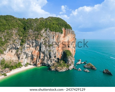 Top aerial drone view of the beautiful Railay Beach in Thailand. Panoramic view of an idyllic beach with huge limestone cliffs from above, turquoise ocean, tropical island