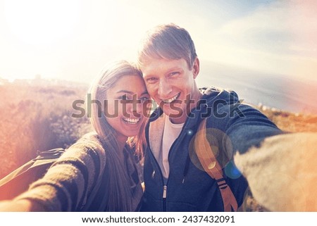 Hiking, selfie and couple hug in nature with love, trust and bonding outdoor together. Backpack, travel or people portrait in countryside for adventure, vacation or romantic profile picture at sunset
