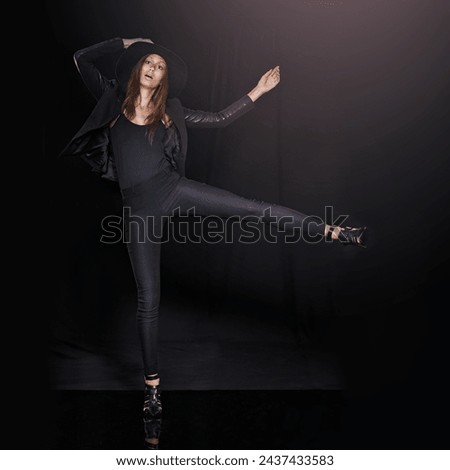 Portrait, fashion and balance with woman on black background in studio for clothing dance. Leather, model and outfit with confident young person in dark clothes for chic, edgy or trendy style
