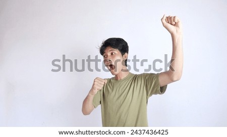 close-up of young handsome Asian man excited and happy with isolated white background