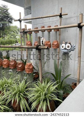 owl-shaped ceramic flower pots in the garden