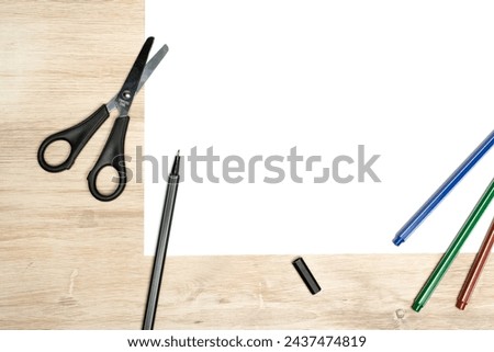 Paper cutting with scissors. A layout of a blank sheet with markers, paper for assignments, a presentation of the design of paper crafts, a template. Royalty-Free Stock Photo #2437474819