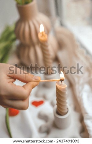 Girl lights a candle, spring aesthetics.