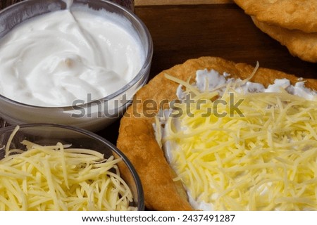 Hungarian deep-fried flatbread - Lángos Royalty-Free Stock Photo #2437491287