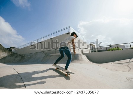Skateboarder skateboarding at skatepark in city Royalty-Free Stock Photo #2437505879
