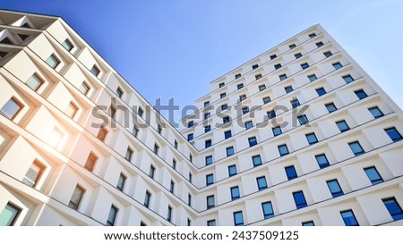 View of a white modern apartment building. Perfect symmetry with blue sky. Geometric architecture detail modern concrete structure building. Abstract concrete architecture. 