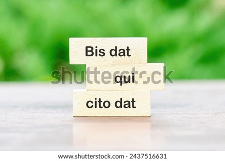 Bis dat qui cito dat It is translated from Latin as The one who gives twice is the one who gives quickly written on wooden blocks