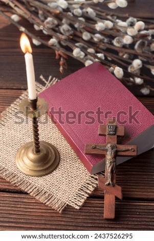Crucifixion on the cross and prayer book. Burning church candle and willow twigs, Orthodox fast