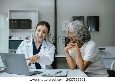 Female doctor consulting senior old patient filling form at consultation, talking to senior old patient filling signing medical paper at appointment visit in clinic.