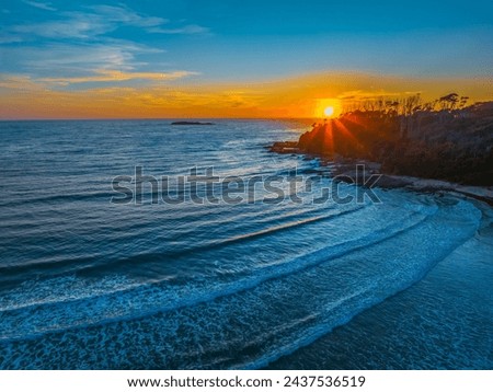 Early morning aerial views over the sea and lagoon at Lilli Pilli Beach in the Eurobadalla Shire on the South Coast, NSW, Australia. Royalty-Free Stock Photo #2437536519