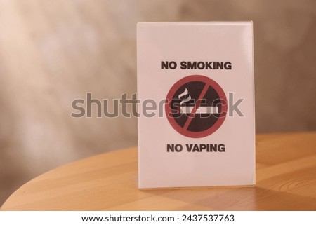 No Smoking sign on wooden table indoors, space for text
