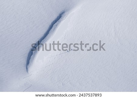 People Hiking Mountains in the Snow,  Mountaineers Walking Creating Symmetrical Shapes Photo, Palandoken Mountains Erzurum, Turkiye (Turkey) Royalty-Free Stock Photo #2437537893