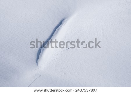 People Hiking Mountains in the Snow,  Mountaineers Walking Creating Symmetrical Shapes Photo, Palandoken Mountains Erzurum, Turkiye (Turkey) Royalty-Free Stock Photo #2437537897